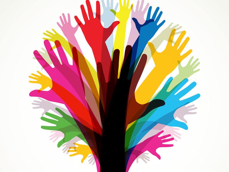 Group of multi-colored hands together making the shape of a tree