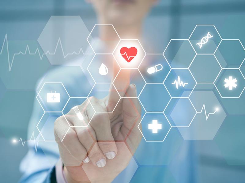 Finger touching heart shape on digital display