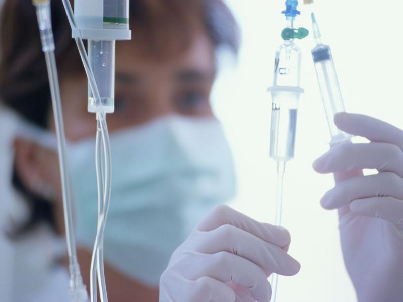 Health care worker adjusting drips