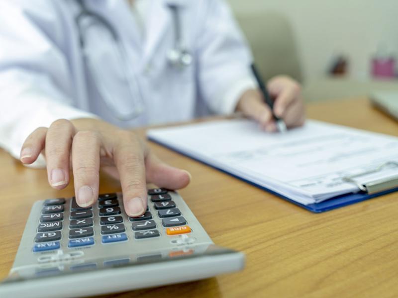 Physician using a calculator