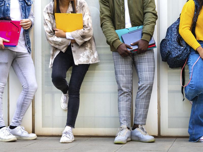 Group of teenagers standing in a line at school