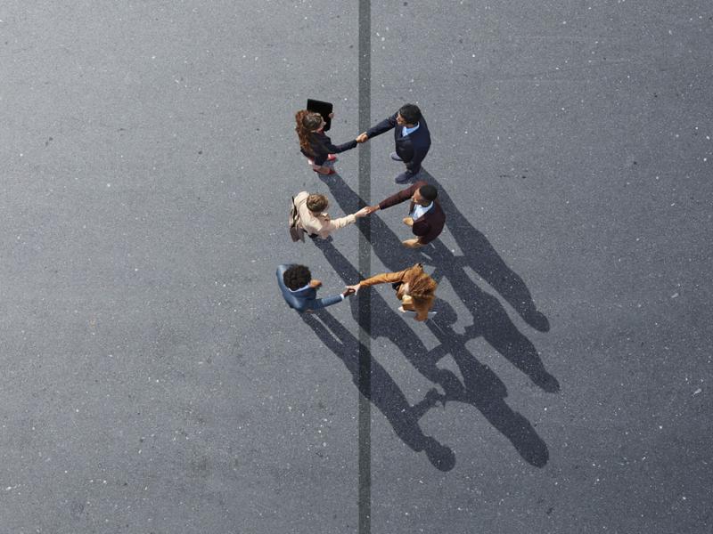 Group of six people shaking hands