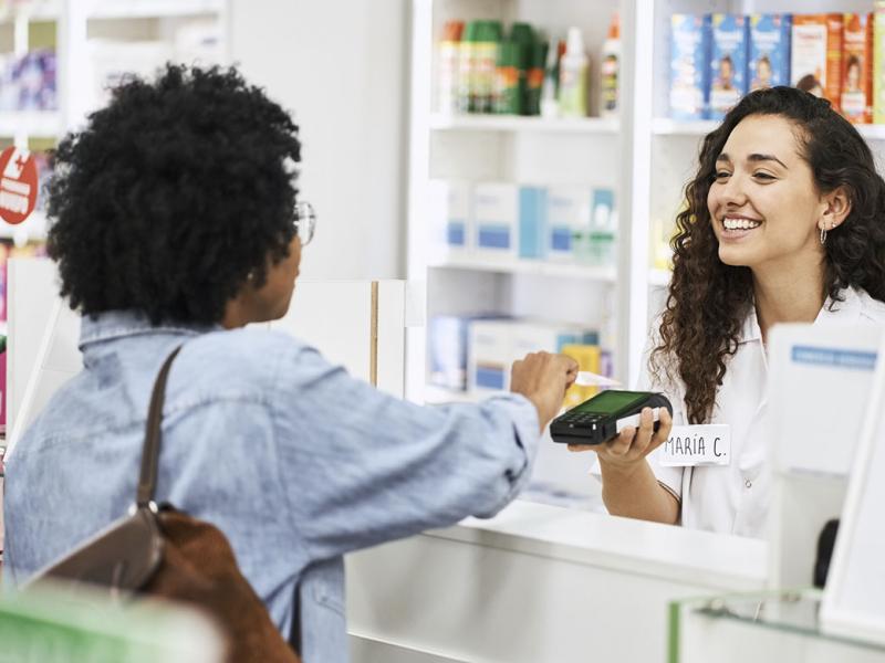 Female customer makes a purchase at a pharmacy
