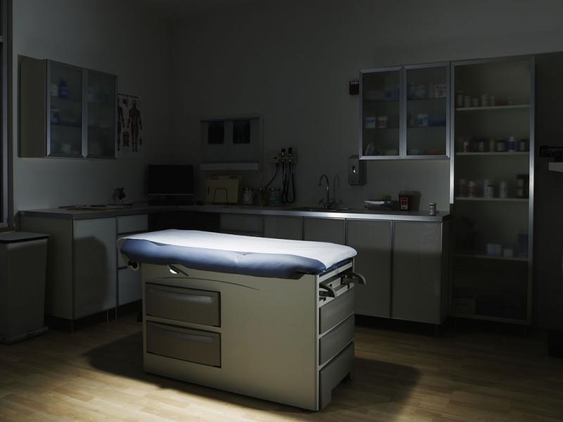 Empty, dimly lit examination room