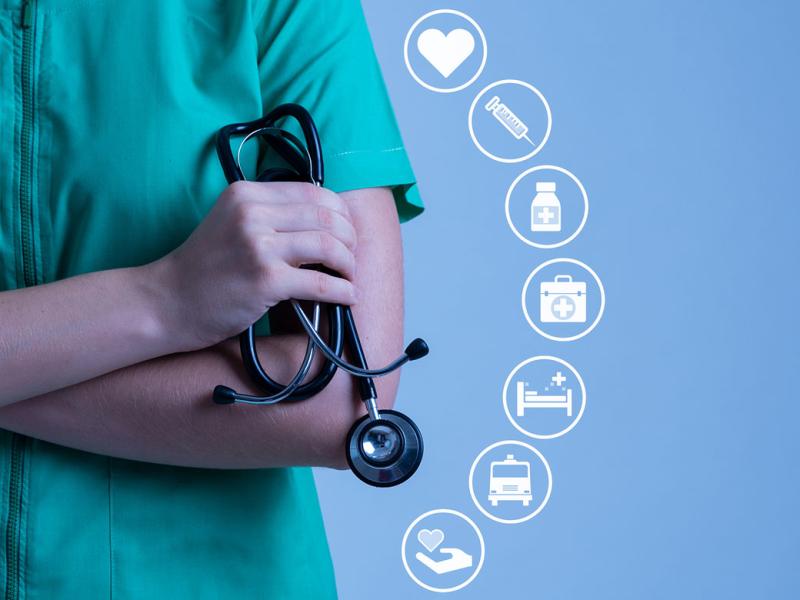 Health care worker holding stethoscope accompanied by health-related icons