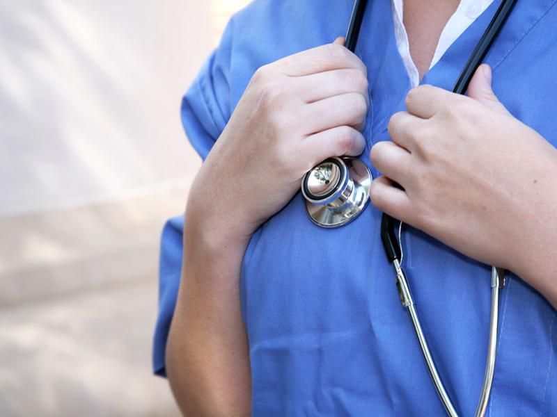 Closeup of doctor holding stethoscope