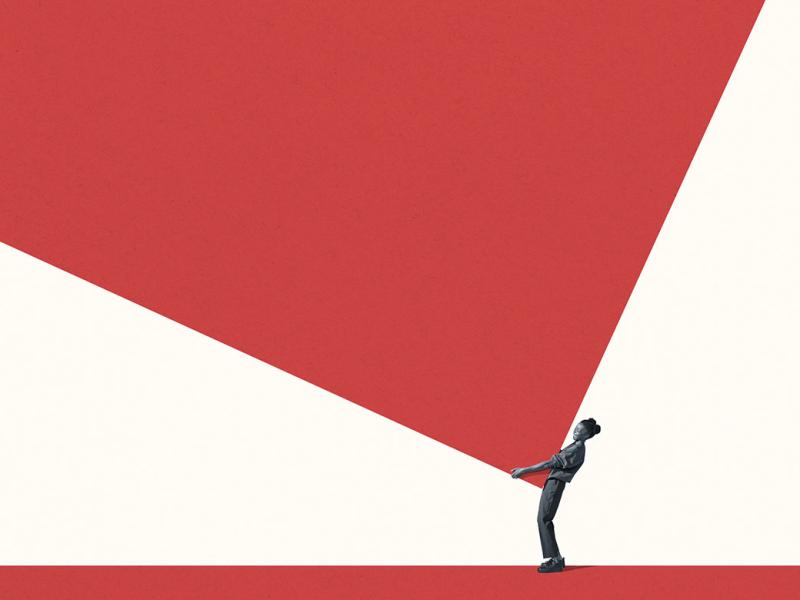 Full length side view of young woman carrying large block