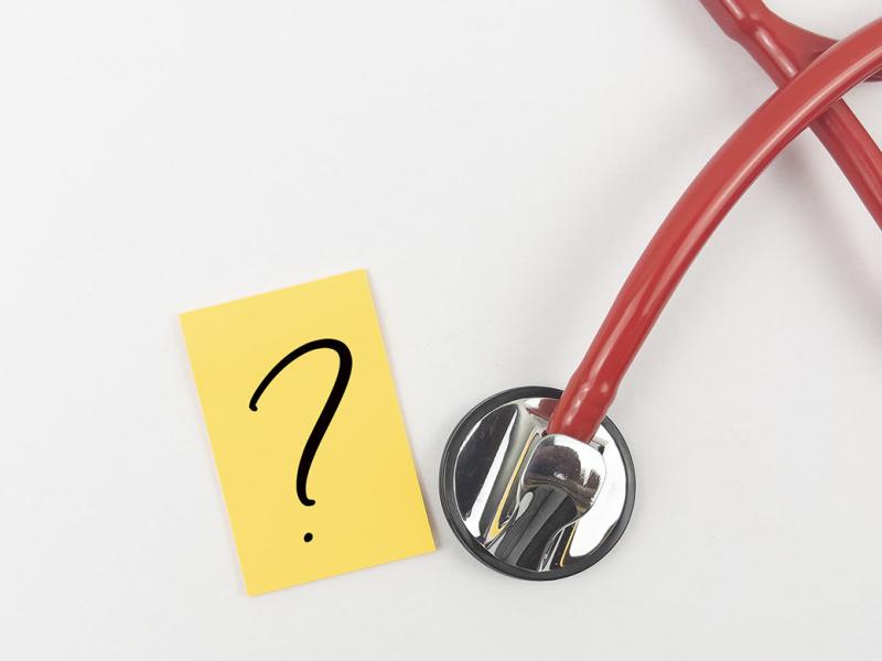 Paper with a question mark next to a stethoscope