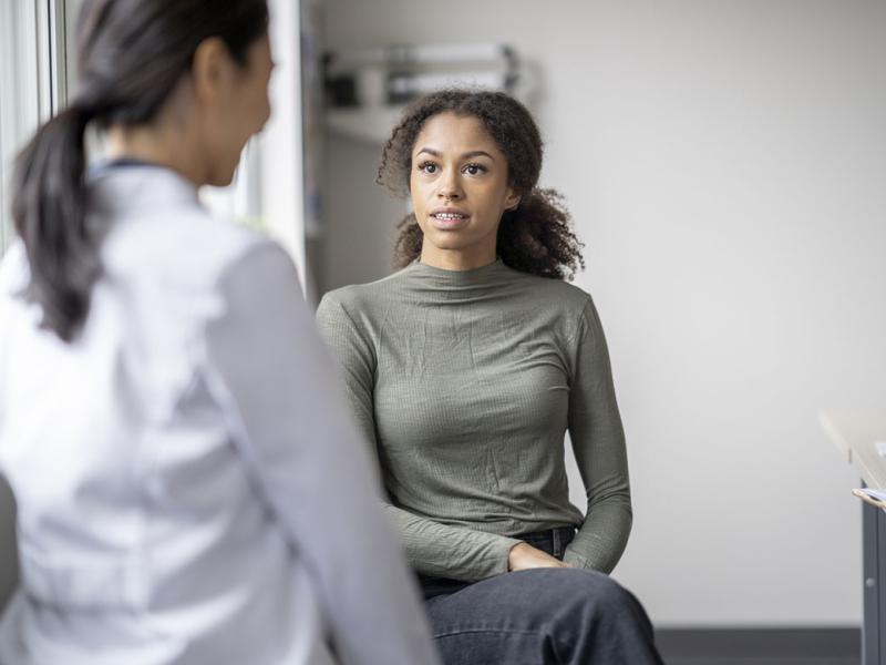 Patient speaking with doctor in an exam room
