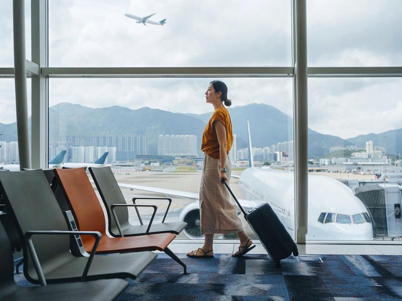 Traveler wheeling luggage through an airport