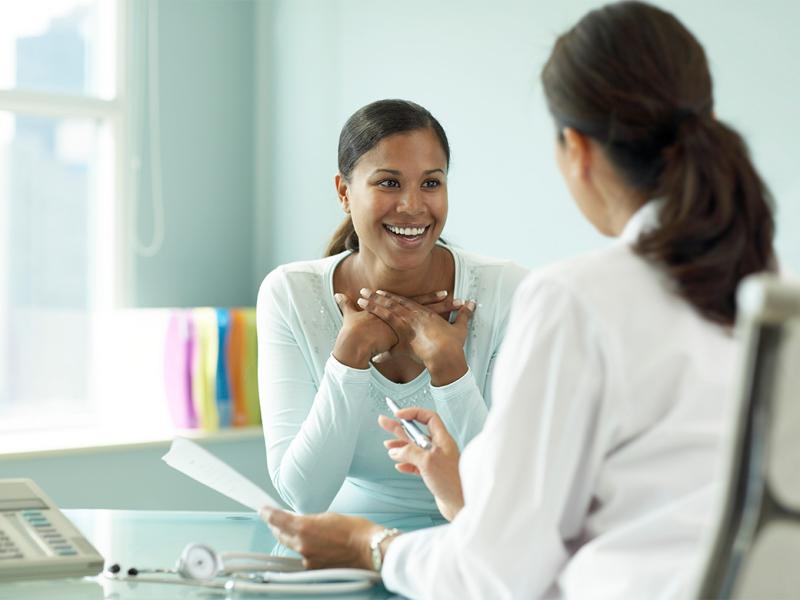 Smiling patient speaking with physician