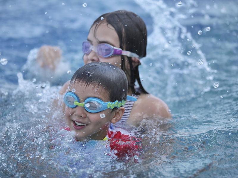 Two happy children swimming