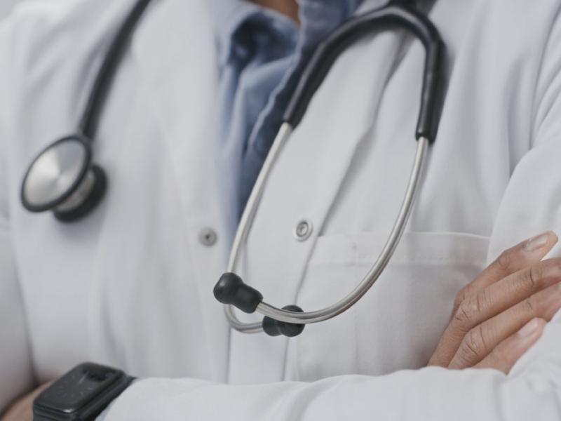 Physician with arms crossed