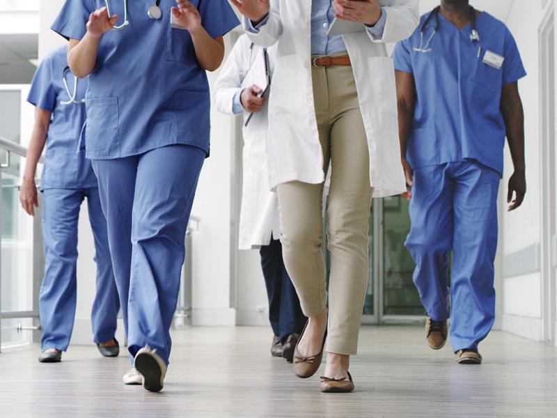 Group of health care workers walking down a hallway