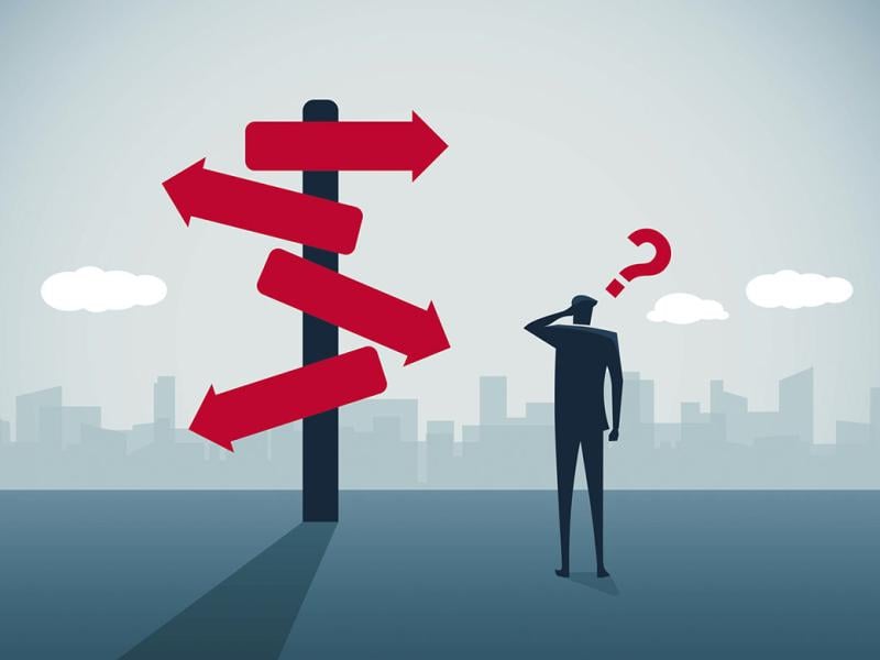 Figure stands near a sign with multiple directions, question mark above head