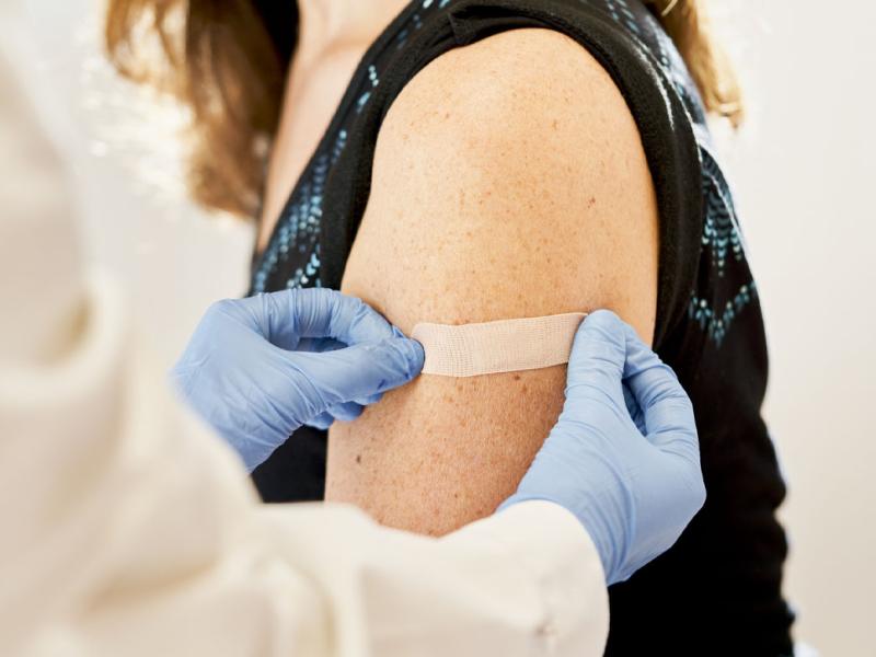 Adhesive bandage is applied to a patient's upper arm
