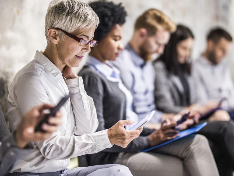 Group of people looking at their cell phones