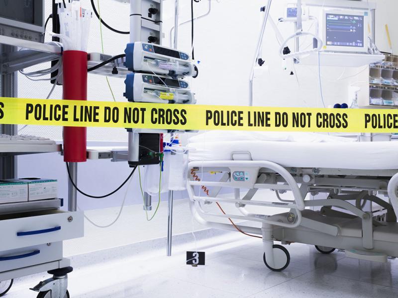 Empty hospital room with police line do not cross