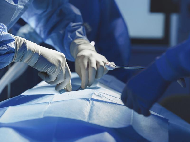 Close-up of surgeon with nurse and and assistant during operation