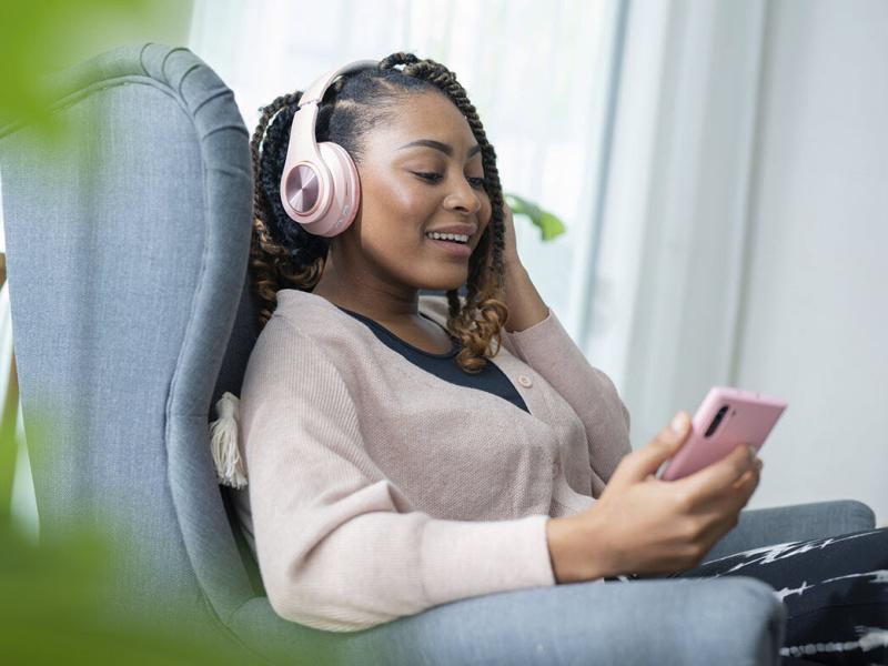 Woman wearing headphones, listening to podcast
