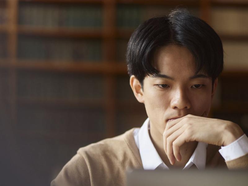 Student studying in front of a laptop