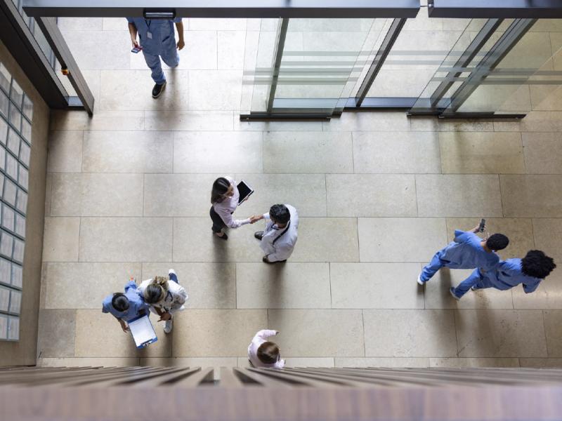Group of people walking through an entrance hall at a hospital 