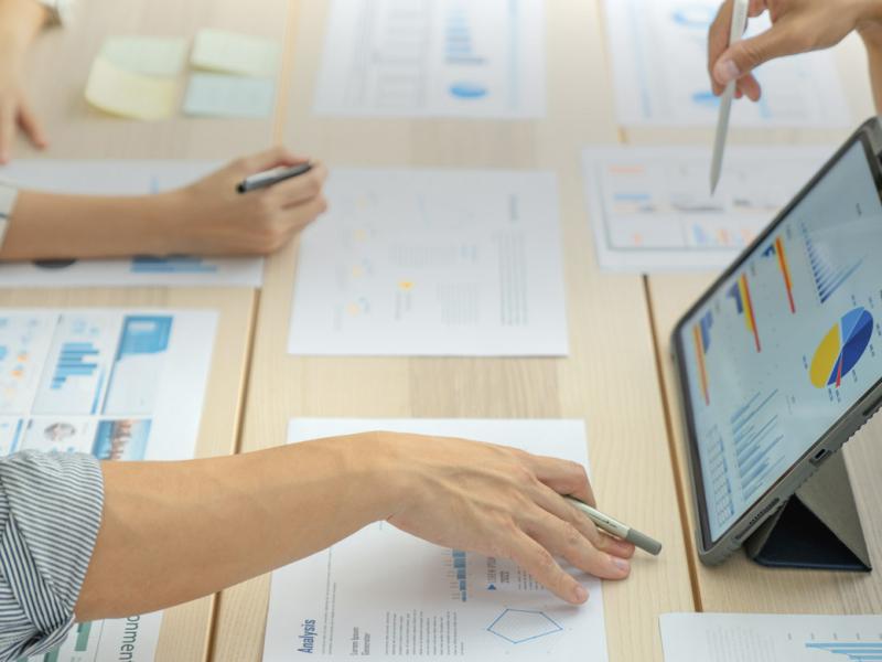 Business colleagues analyzing financial charts and graphs