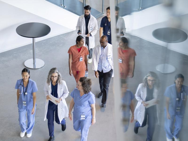 A group of health care workers walk in a hall