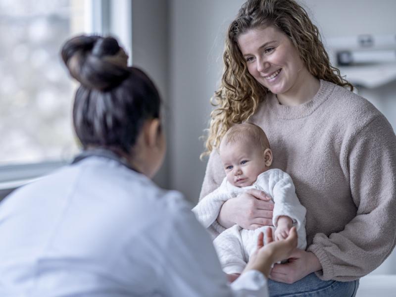 Baby holding a doctor's finger