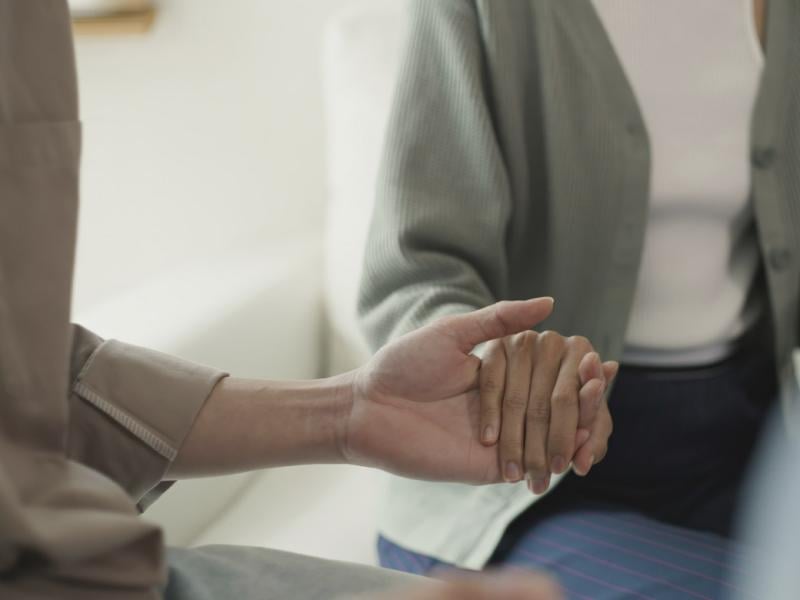 Supportive group holding hands