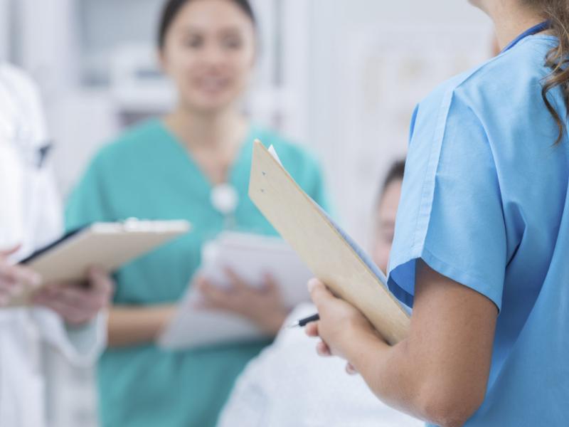 Health care workers in patient's hospital room
