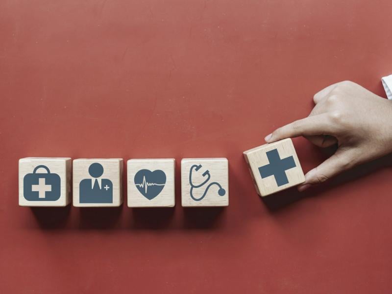 Hand placing blocks in a row