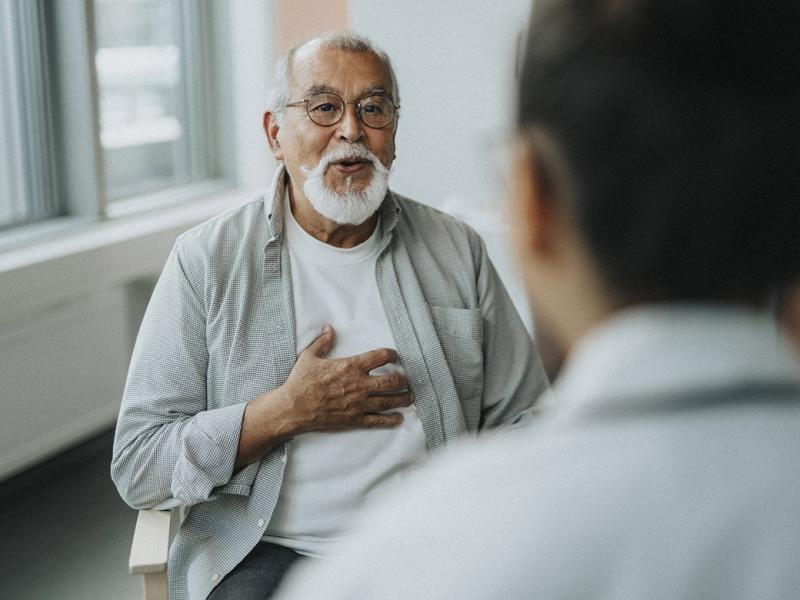 Elderly patient gestures to chest