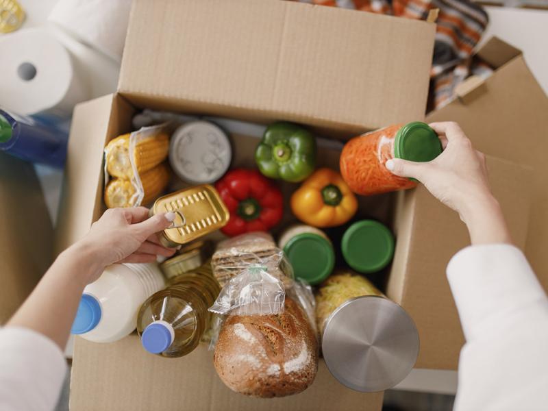 Person packing up food in a box