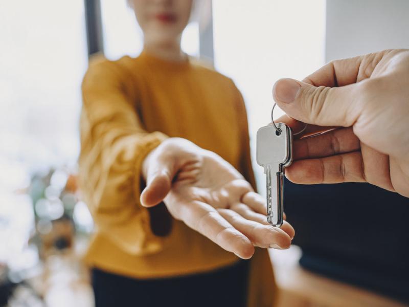 Outstretched hand waits for keys from another hand