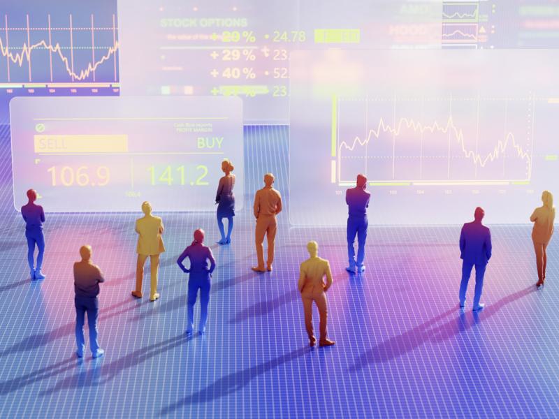 Figures stand in front of large data graphs