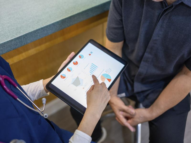 Physician points at tablet