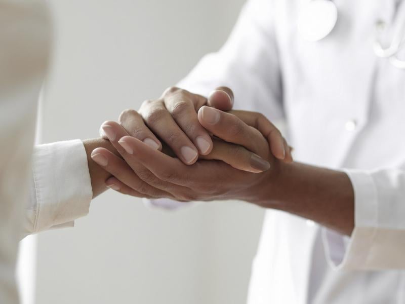 Doctor holds a comforting hand