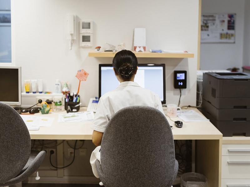 Physician working at a computer