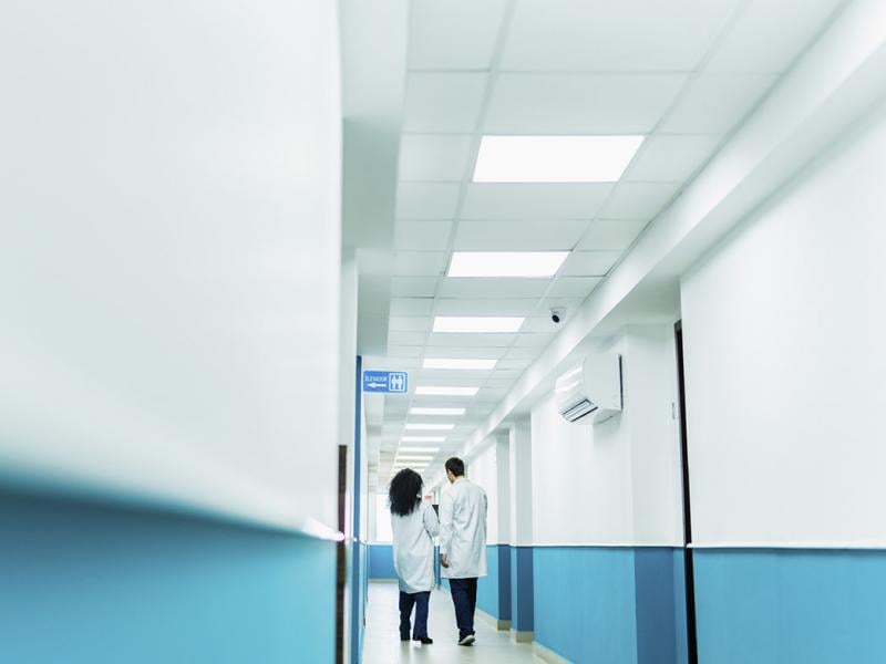 Two health care workers in a hallway