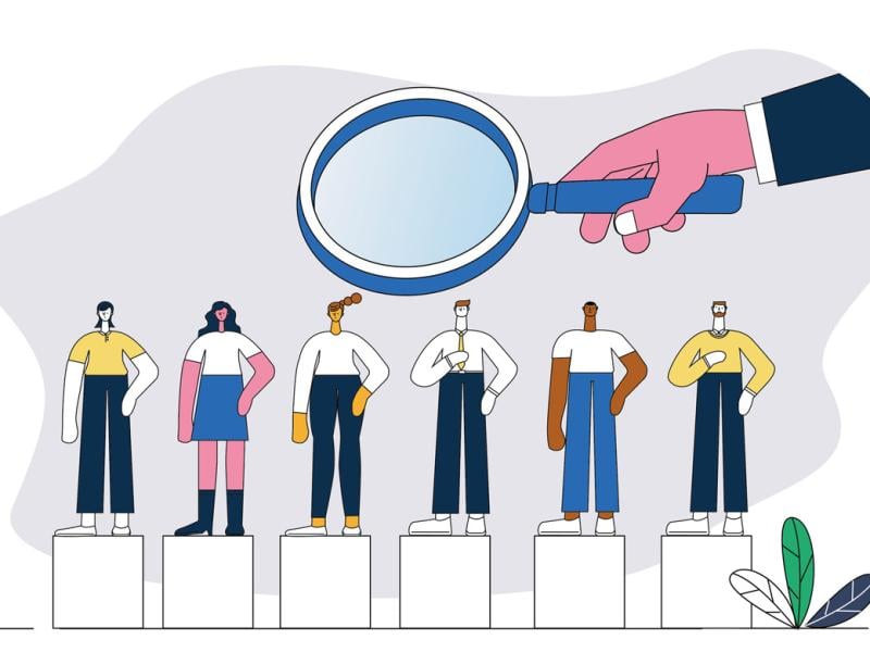 Giant magnifying glass hovers over a row of figures