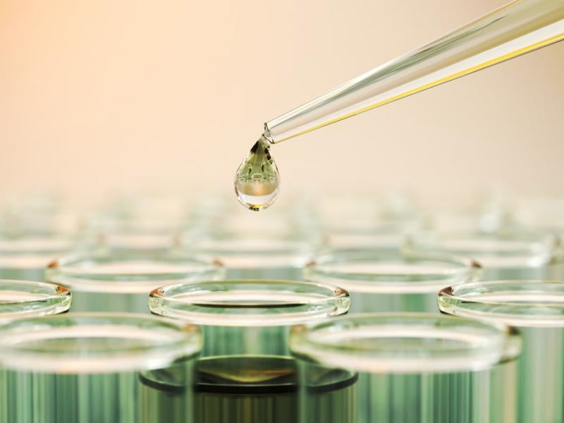 Testing liquid from pipette into test tubes