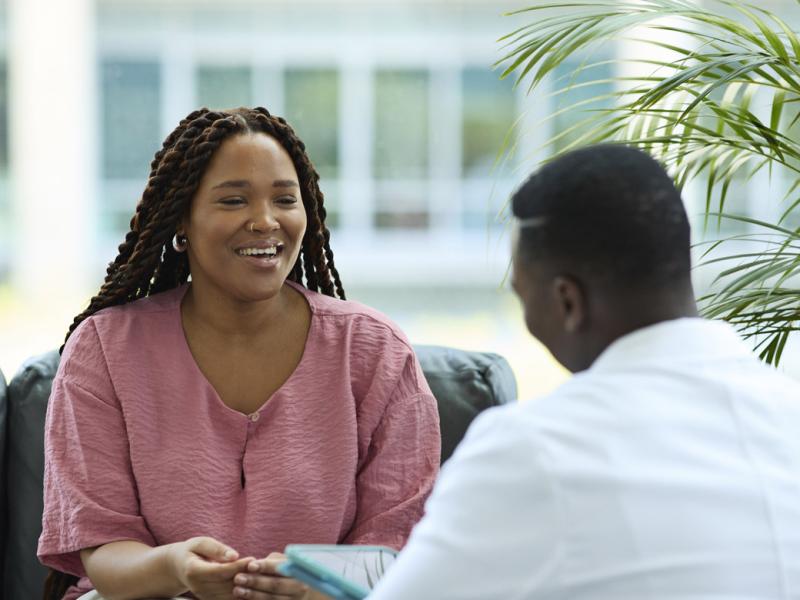 Smiling patient meets with doctor