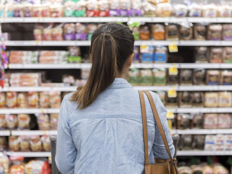Shopper in the bread aisle of a grocery store