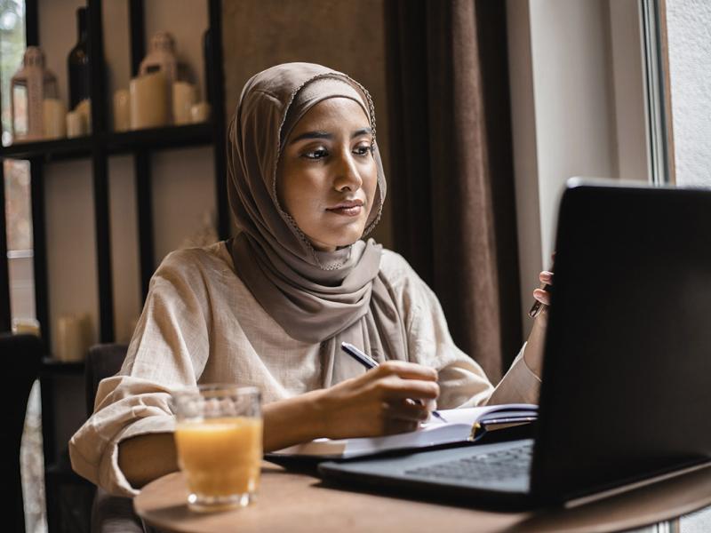Person works in front of a laptop