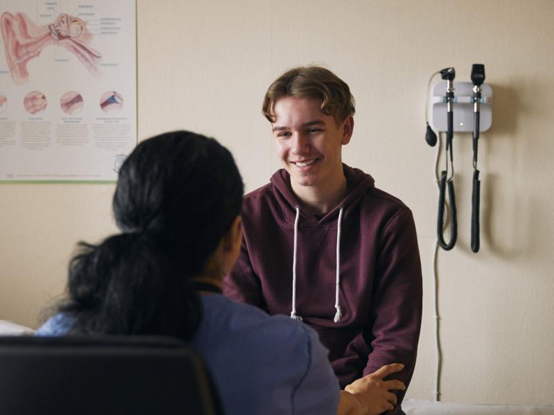 Smiling teenage patient in doctor's office