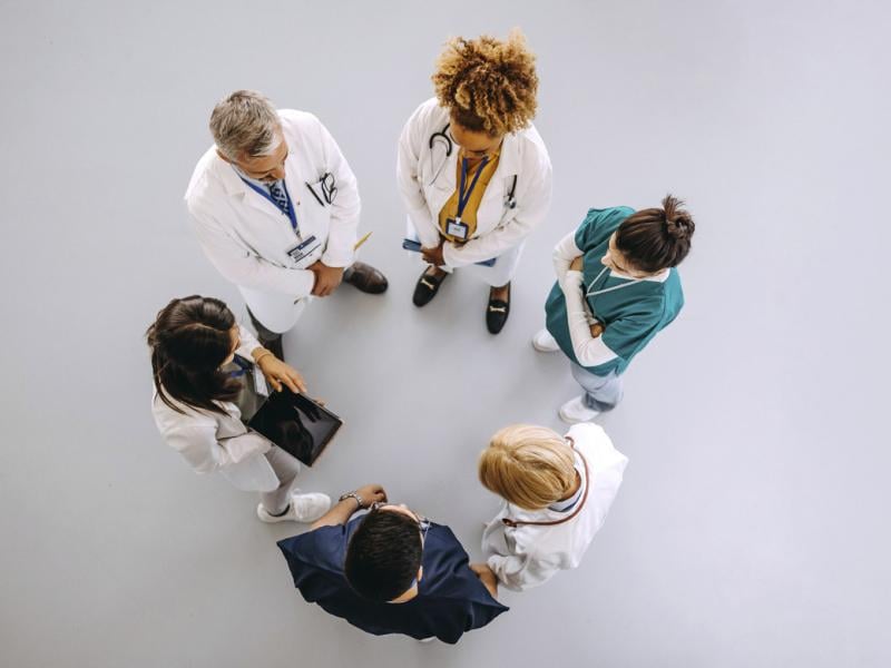 Healthcare team stands in a circle