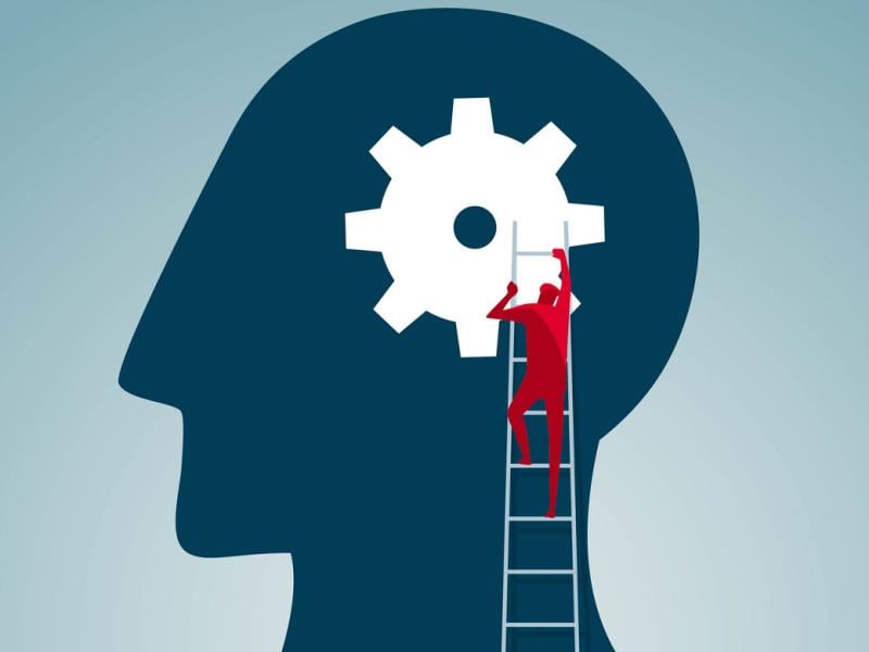 Figure climbs a ladder toward a giant gear in a human profile