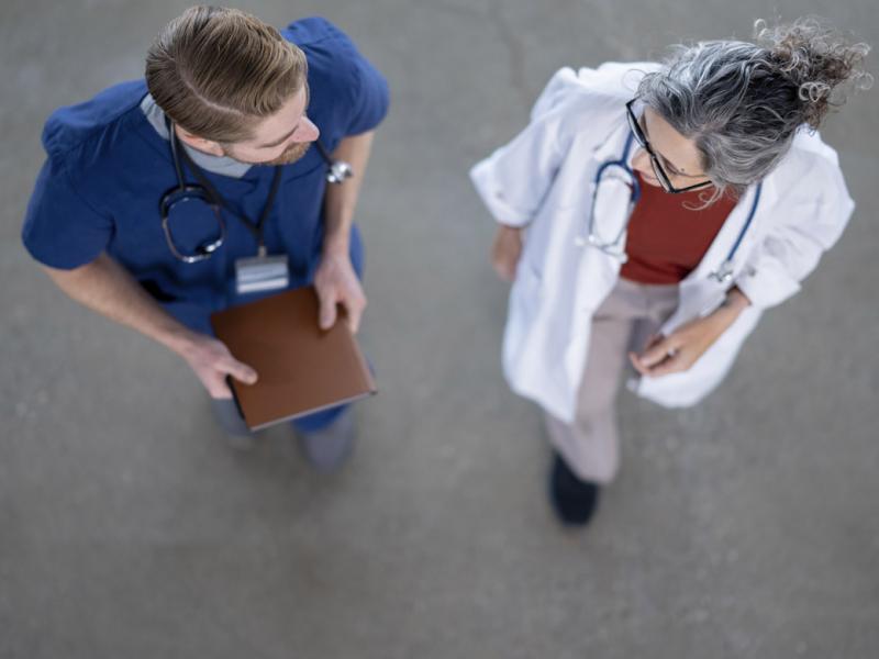 Two healthcare workers in conversation