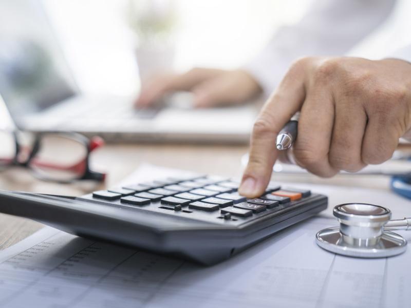 Physician uses a calculator